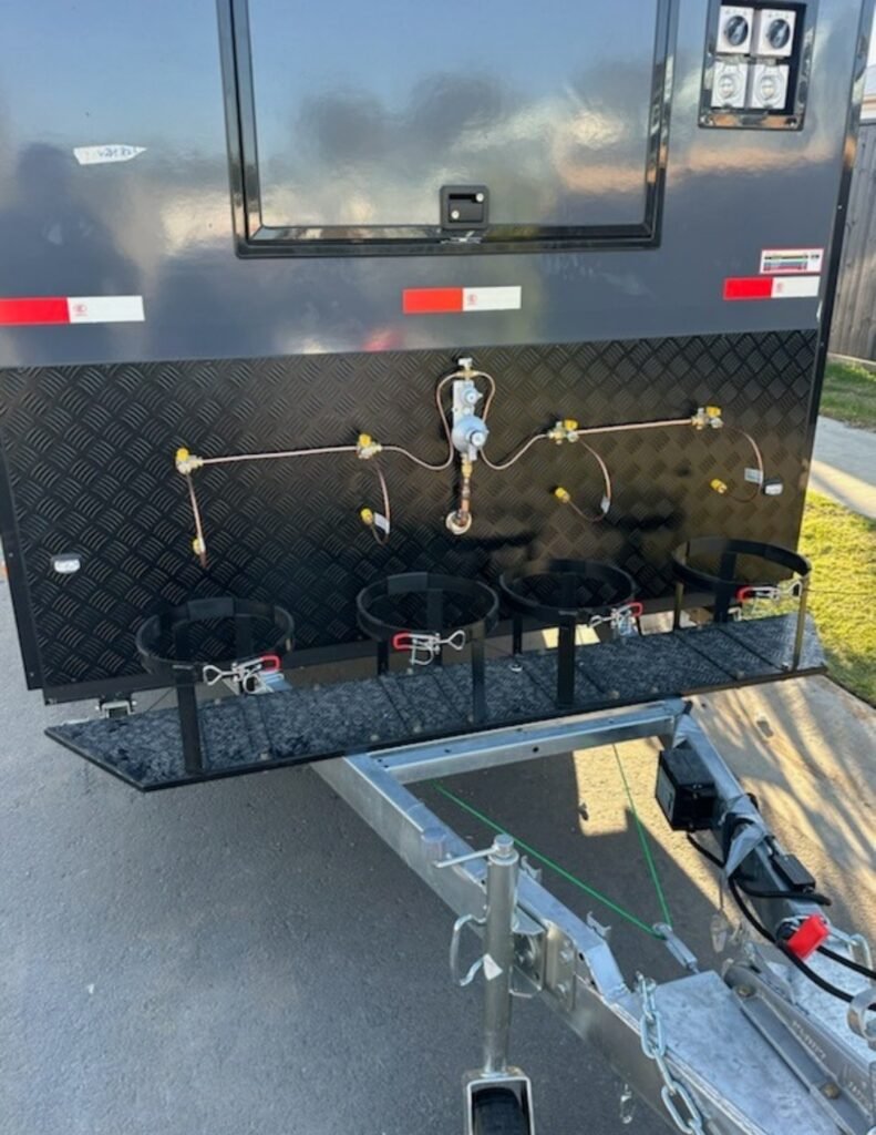 Rear gas manifold on a food trailer with four burner outlets and copper gas lines installed by LTC Gas